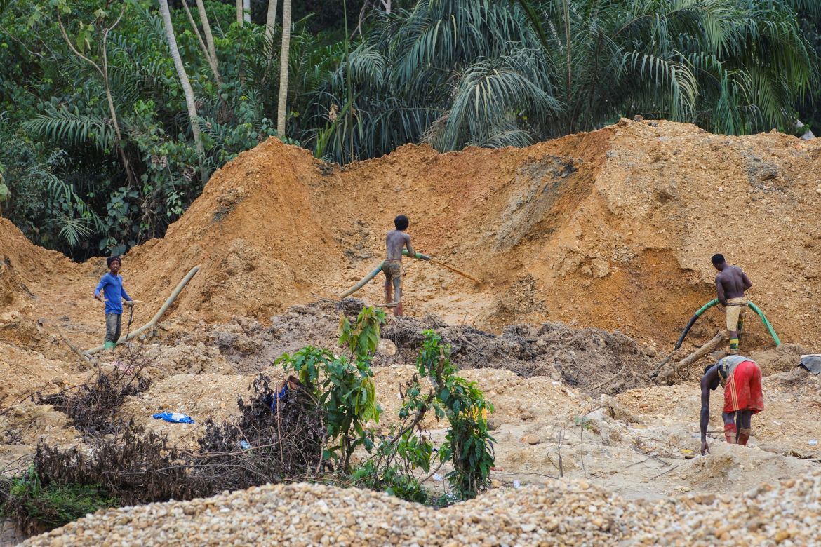 Young men engage in small-scale gold mining on a destroyed cocoa plantation in the Samreboi community in the Western Region, Ghana, February 26