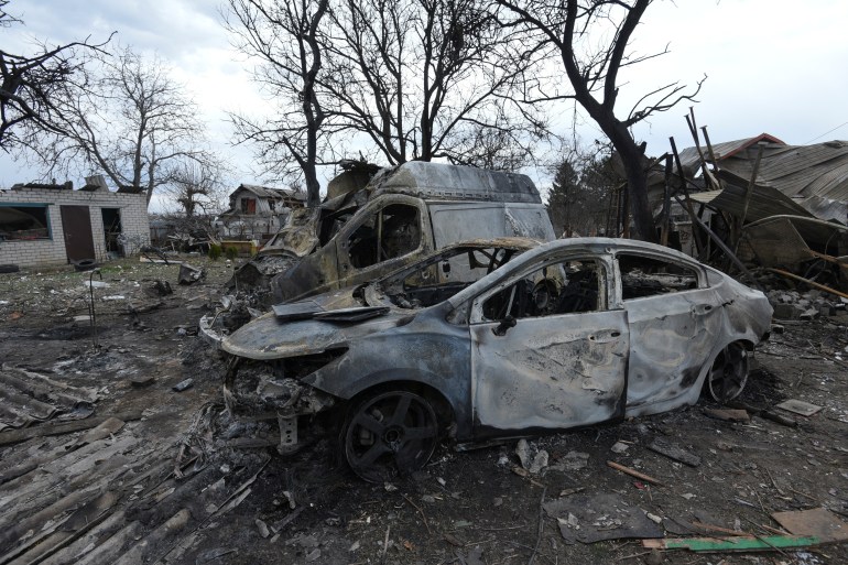 Burned cars and damaged residential buildings are seen at a site of a Russian missile and drone strike,