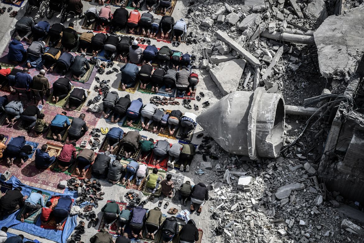 RAFAH, GAZA - MARCH 01: An aerial view of Palestinians performing Friday prayers among the rubble of the Al-Farooq Mosque, destroyed in an Israeli attack on March 01, 2024 in Rafah