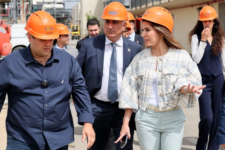 Mohamed Reza Pahlavi and his wife in hard hats on a site