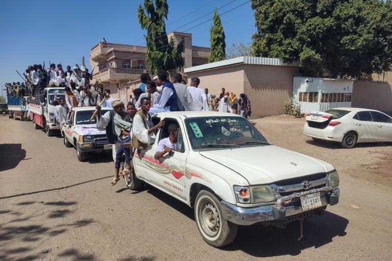 Supporters of the Sudanese armed popular resistance, which backs the army, ride on trucks in Gedaref in eastern Sudan on March 3, 2024
