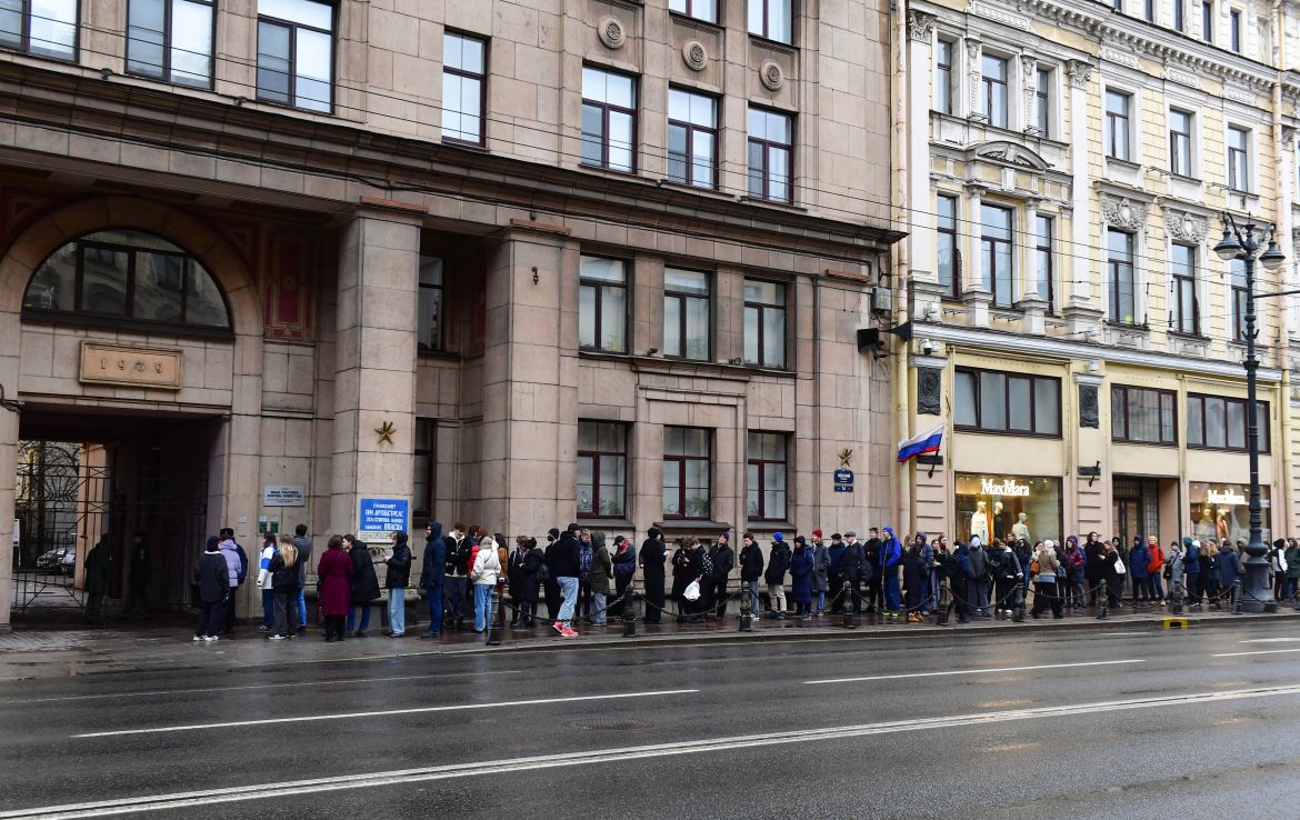 People queue outside a polling station during Russia's presidential election in Saint Petersburg on March 17