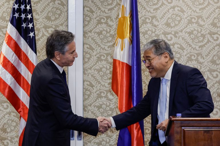 US Secretary of State Antony Blinken (L) and Philippine Secretary of Foreign Affairs Enrique Manalo shake hands after a joint press conference at the Sofitel Hotel in Manila