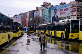 A pedestrian walks past an electoral poster displaying Republican People&#039;s Party (CHP) candidate Ekrem Imamoglu in Istanbul before the March 31 municipal elections [Yasin Akgul/AFP]