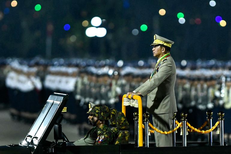 Ming Aung Hlaing stands on the back of an open-topped military vehicle during Wednesday night's parade.