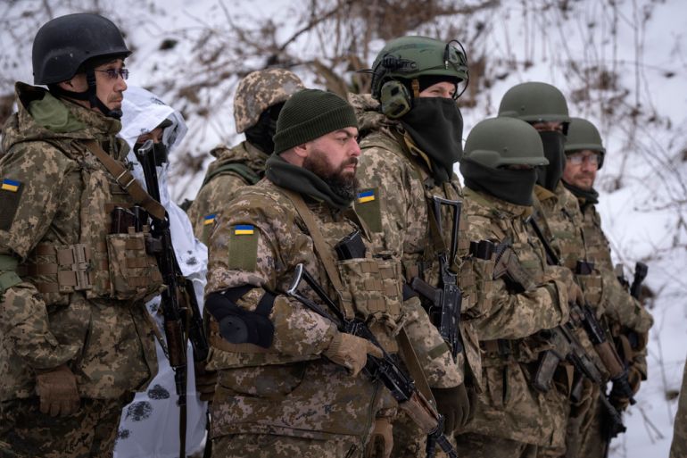 Members of the pro-Ukrainian Russian ethnic Siberian Battalion practice at a military training close to Kyiv, Ukraine, Wednesday, Dec. 13, 2023