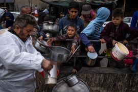 Palestinians line up for free food in Rafah, Gaza Strip
