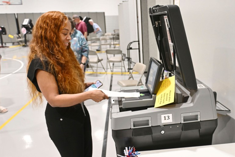Voter scans her ballot