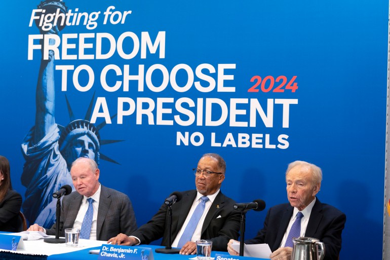 Joe Lieberman sits on a No Labels panel with two other people under the slogan "Fighting for freedom to choose a president. No Labels."