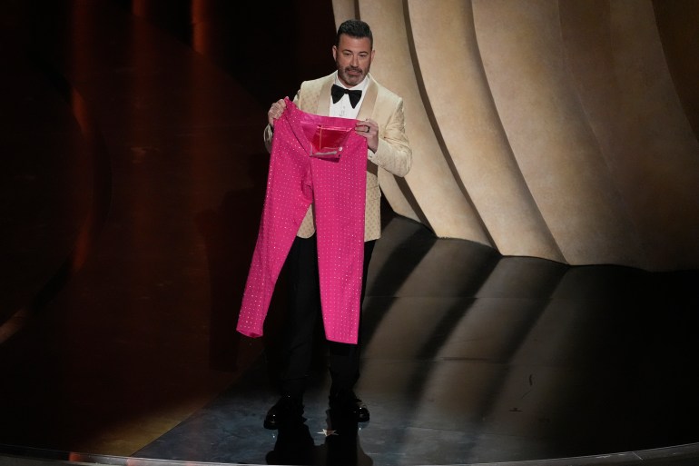 Jimmy Kimmel holds up a pair of pink sparkly pants.