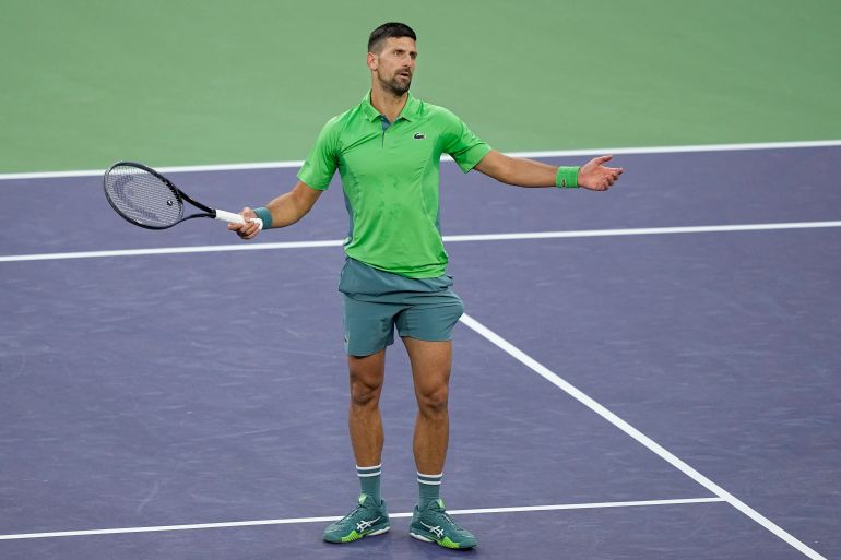 Novak Djokovic, of Serbia, reacts after losing a point against Luca Nardi, of Italy, at the BNP Paribas Open tennis tournament, Monday, March 11, 2024, in Indian Wells, Calif.