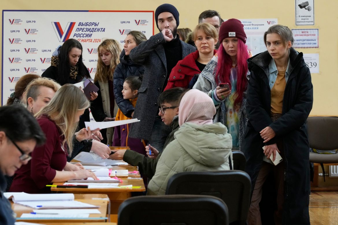 Voters queue at a polling station in St. Petersburg, Russia, at noon local time on Sunday, March 17