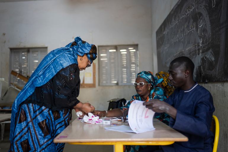 A woman votes in Senegal's election