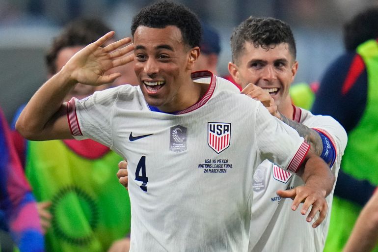 United States midfielder Tyler Adams (4) celebrates his goal with forward Christian Pulisic during the first half of a CONCACAF Nations League final soccer match against Mexico, Sunday, March 24, 2024, in Arlington, Texas. (AP Photo/Julio Cortez)