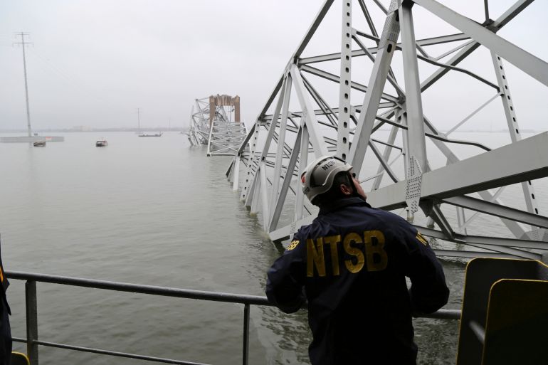 In this image released by the National Transportation and Safety Board, a NTSB investigator is seen on the cargo vessel Dali, which struck and collapsed the Francis Scott Key Bridge, Wednesday, March 27, 2024 in Baltimore.