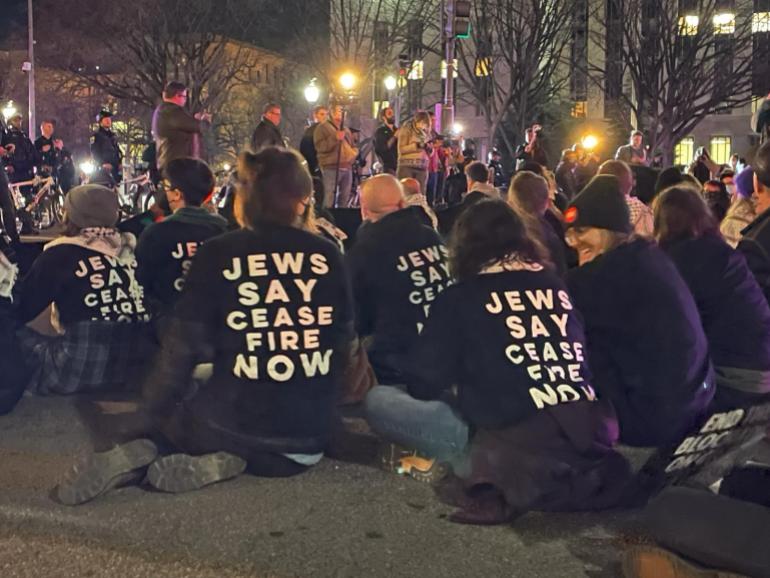 Protesters with shirts that read, "Jews say ceasefire now"