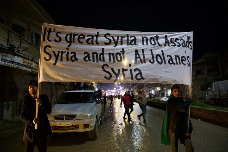 Banner held up saying 'It's great Syria not Assad Syria and not Al Jolane's Syria'