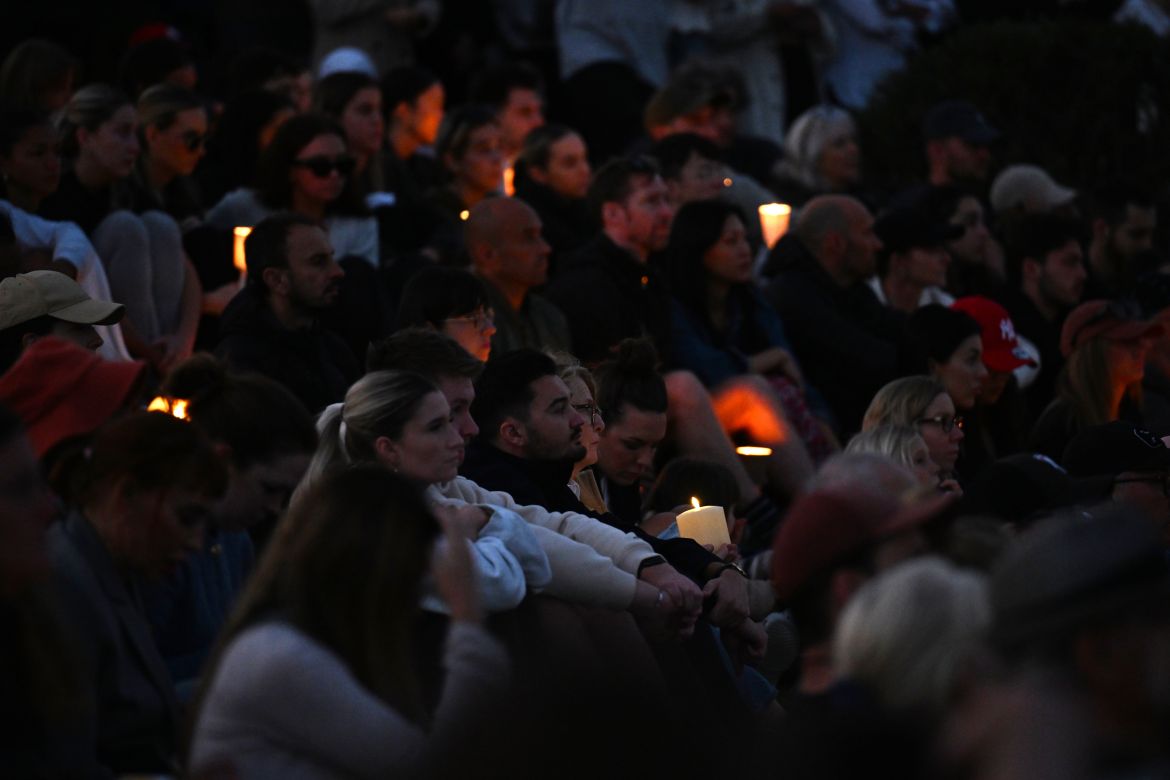 People gather during a candlelight vigil to honour the victims of the Bondi Junction tragedy at Bondi Beach, in Sydney, Australia, 21 April