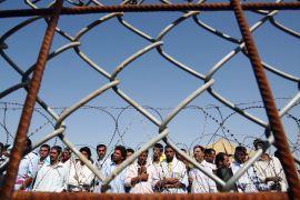 Iraqi prisoners wait to be released at Abu Ghraib prison, west of Baghdad, on June 23, 2006 [Wathiq Khuzaie/Pool/Reuters]