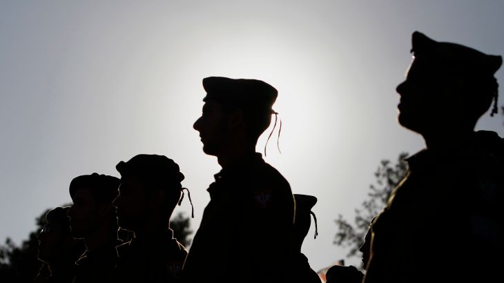 Israeli soldiers of the Netzah Yehuda Haredi infantry battalion stand at attention during their swearing-in ceremony in Jerusalem May 26, 2013.