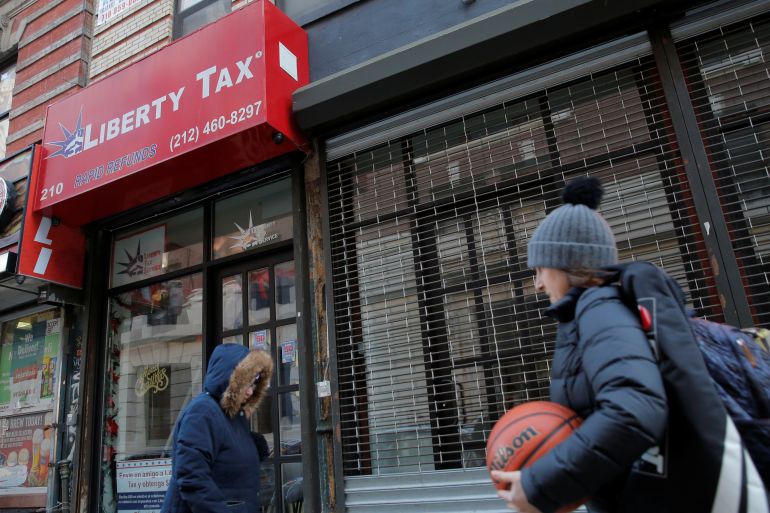 People walk by a Liberty Tax office ahead of Tax Return season in Manhattan, New York, US, December 28, 2017