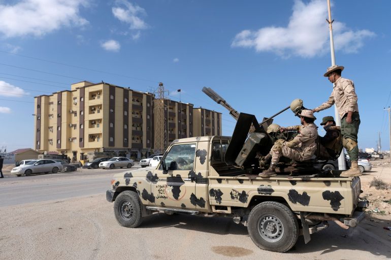 Security forces stand guard outside the Parliament building, in Tobruk