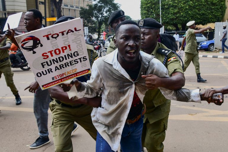Police officers detain a Ugandan activist participating in a demonstration over proposed plans by Total Energies and the Ugandan government to build the East African Crude Oil Pipeline (EACOP), in Kampala, Uganda September 15, 2023. REUTERS/Abubaker Lubowa
