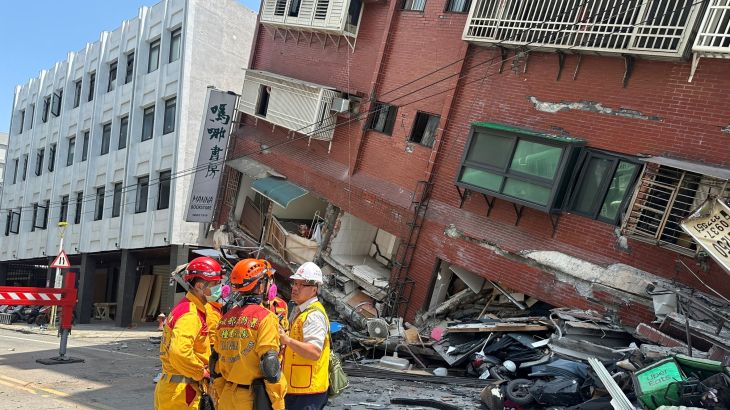 Firefighters work at the site where a building collapsed