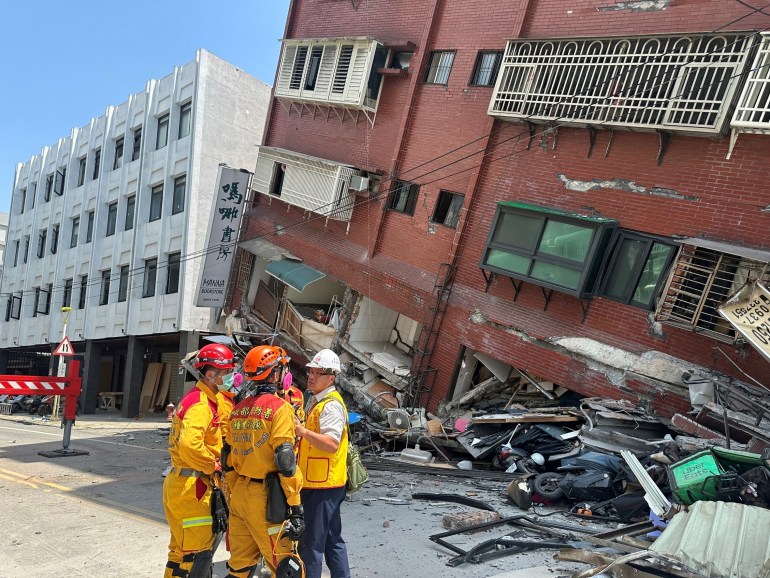 Firefighters work at the site where a building collapsed