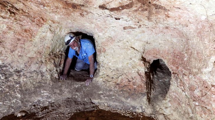 Yinon Shivtiel, a historian at Zefat Academic College crawls through an opening in a cave, part of an immense underground hideout comprising narrow tunnels and large storage spaces