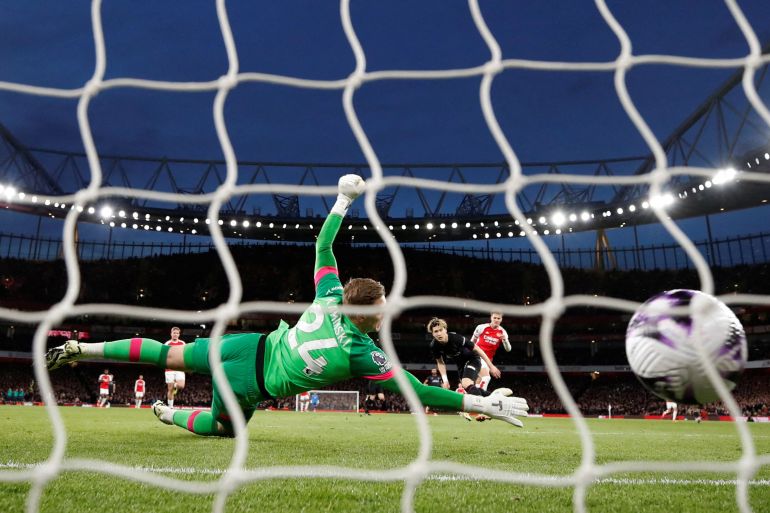 Arsenal's Martin Odegaard scores their first goal past Luton Town's Thomas Kaminski