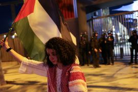 Palestinian Mervat Alramli cries as she holds her Palestinian flag in protest of the Euroleague basketball game between Barcelona and Maccabi Tel-Aviv outside the stadium in Barcelona, Spain on April 4, 2024 [File: Reuters/Nacho Doce]