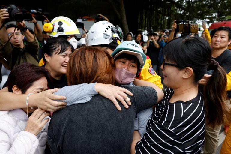 Family members hugging a woman rescued after the Taiwan earthquake