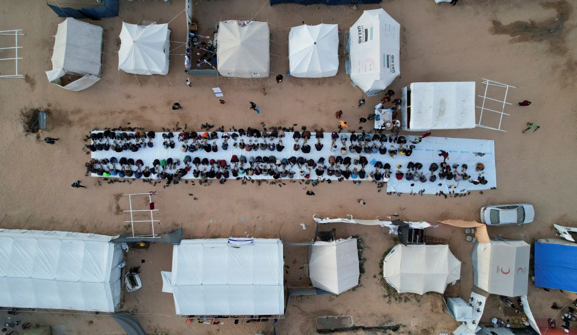 A drone view shows Palestinians, who were displaced by Israel's military offensive, gathering to have their Iftar (breaking of the fast) during the holy month of Ramadan, in Rafah in the southern Gaza Strip April 6