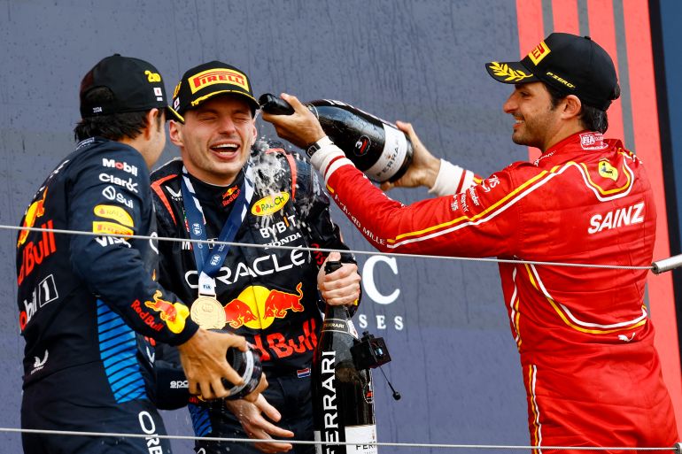Max Verstappen has champagne sprayed on him on the podium at the Japanese Grand Prix .