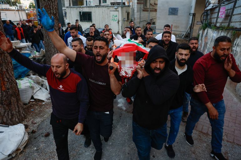 Mourners carry the body of a Palestinian who died during an Israeli settler attack on their village of al-Mughayyir, in Ramallah