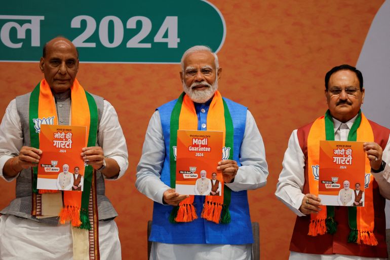 Indian Defence Minister Rajnath Singh, Prime Minister Narendra Modi and President of the Bharatiya Janata Party J. P. Nadda display copies of the ruling Bharatiya Janata Party's (BJP) election manifesto for the general election, in New Delhi, India