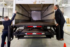 Police officers in Brampton, Ontario, open the back of a truck they say was used in a 2023 gold heist for a news conference on April 17 [Carlos Osorio/Reuters]