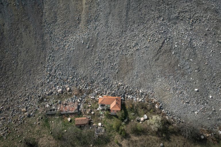 A destroyed house is seen near an open-pit copper mine, run by a subsidiary of China's Zijin Mining, near to the village of Krivelj, Serbia, April 4