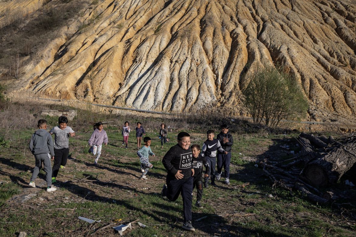 Children play in front of tailings, waste materials left after a mineral is extracted from ore, at the Zmajevo settlement near the village of Krivelj, Serbia, April 4