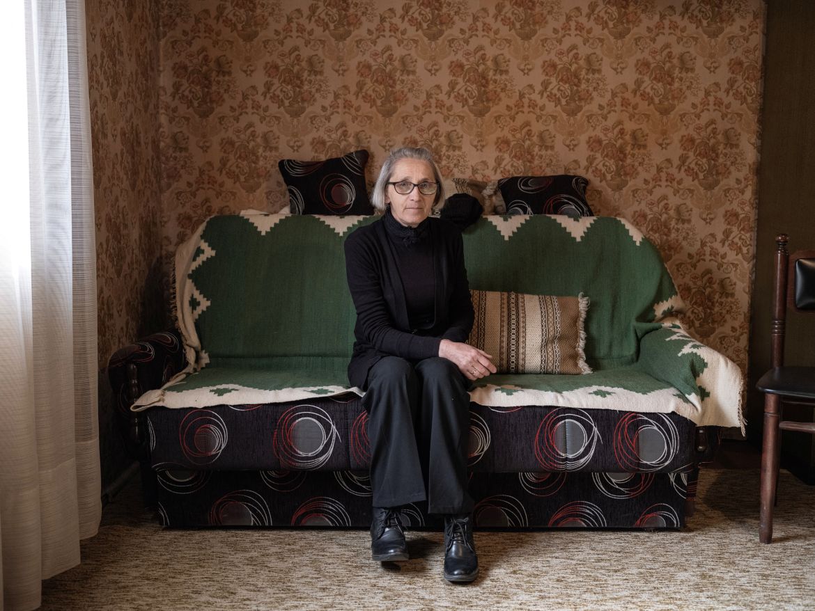 Milosava Fufanovic, who is an elementary school teacher, sits on her sofa as she poses for a picture, at her family home in the village of Krivelj, Serbia, April 3