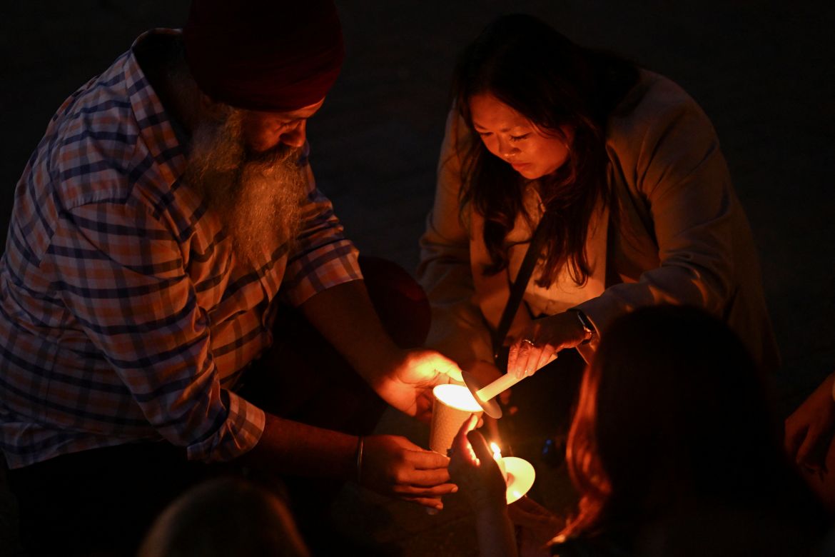 People light candles during the Community Candlelight Vigil, recognising the victims of a fatal stabbing attack at Bondi Junction Westfield shopping centre, in Sydney, Australia, April 21