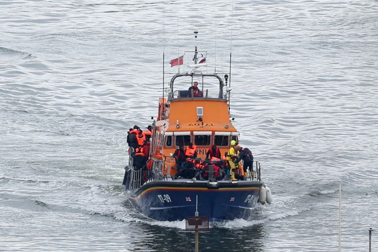 A lifeboat carrying people, believed to be migrants, navigates as seen from the Port of Dover, Britain