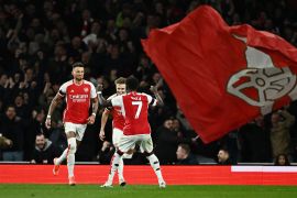 Arsenal&#039;s Ben White celebrates scoring their second goal with Martin Odegaard and Bukayo Saka [Dylan Martinez/Reuters]