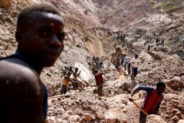 Labourers work at an open shaft of the SMB coltan mine near the town of Rubaya in the eastern Democratic Republic of the Congo, on August 13, 2019 [Baz Ratner/Reuters]