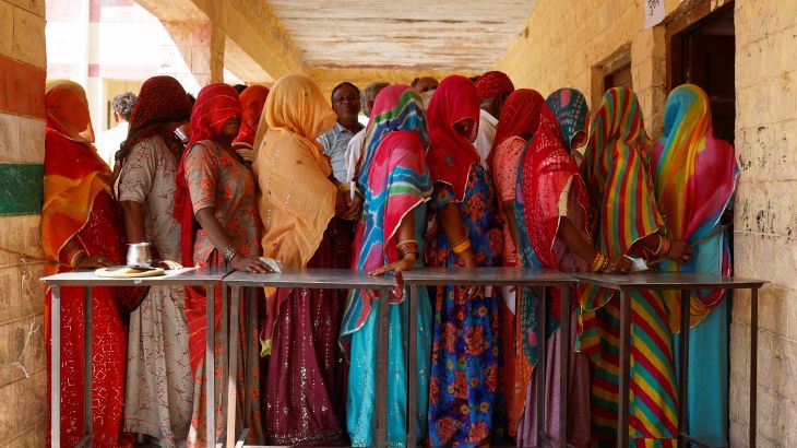 People queue to vote at a polling station during the second phase of the general elections, in Barmer, Rajasthan, India