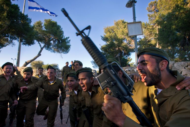 Ultra-Orthodox Jewish fighters from the Netzah Yehuda Battalion in the Israeli army present arms during their swearing-in ceremony