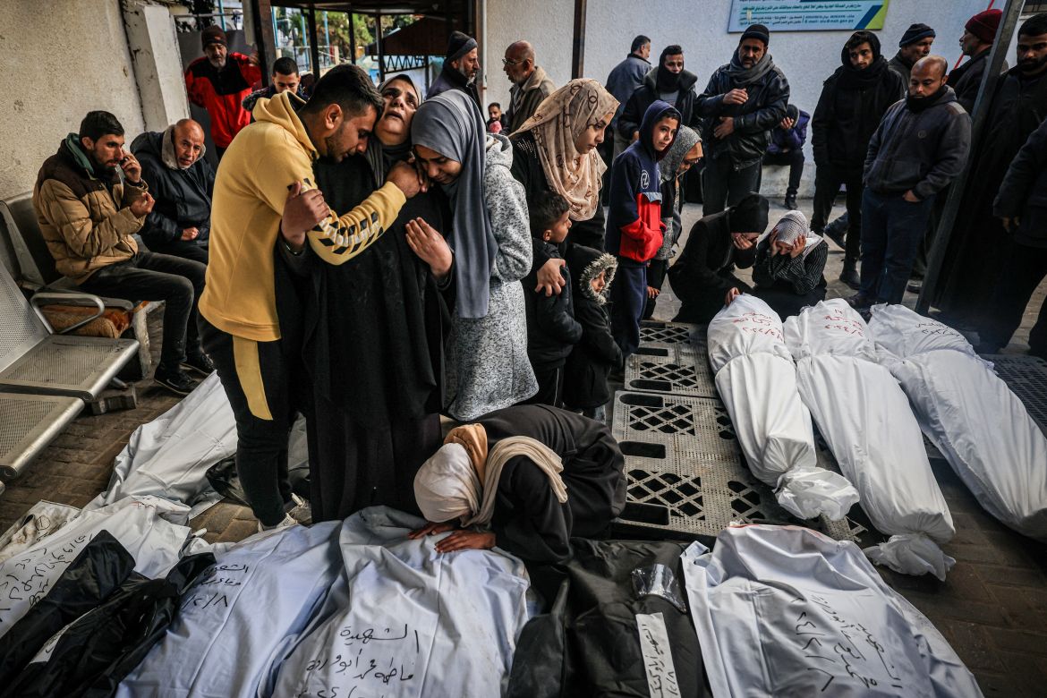 Palestinians mourn after identifying corpses of relatives killed in overnight Israeli bombardment on the southern Gaza Strip at Al-Najjar hospital in Rafah on February 8