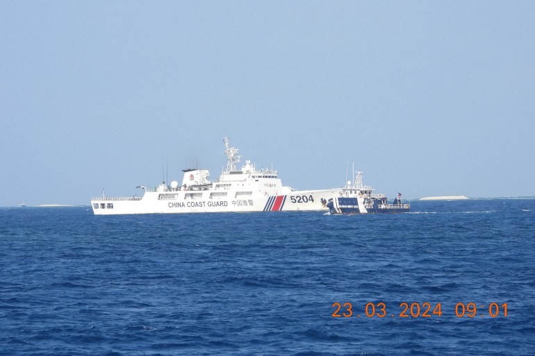 HANDOUTPhilippine Coast GuardAFP This handout photo taken on March 23, 2024 and released by the Philippine Bureau of Fisheries and Aquatic Resources (PCG/BFAR) on March 25, 2024 shows a Chinese Coast Guard ship (L) blocking a Bureau of Fisheries and Aquatic Resources ship (R) on the their way to inspect a cay near the Philippine-held Thitu Island, in the Spratly Islands, in the disputed South China Sea. Deputy foreign ministers from China and the Philippines held a tense phone call on March 25, 2024, Beijing said, after Manila summoned a Chinese envoy over "aggressive actions" by the China Coast Guard in the contested South China Sea. (Photo by Handout / Philippine Coast Guard / AFP) / -----EDITORS NOTE --- RESTRICTED TO EDITORIAL USE - MANDATORY CREDIT "AFP PHOTO /PHILIPPINE COAST GUARD/BUREAU OF FISHERIES AND AQUATIC RESOURCES (PCG/BFAR) " - NO MARKETING - NO ADVERTISING CAMPAIGNS - DISTRIBUTED AS A SERVICE TO CLIENTS - -----EDITORS NOTE --- RESTRICTED TO EDITORIAL USE - MANDATORY CREDIT "AFP PHOTO /PHILIPPINE COAST GUARD/BUREAU OF FISHERIES AND AQUATIC RESOURCES (PCG/BFAR) " - NO MARKETING - NO ADVERTISING CAMPAIGNS - DISTRIBUTED AS A SERVICE TO CLIENTS