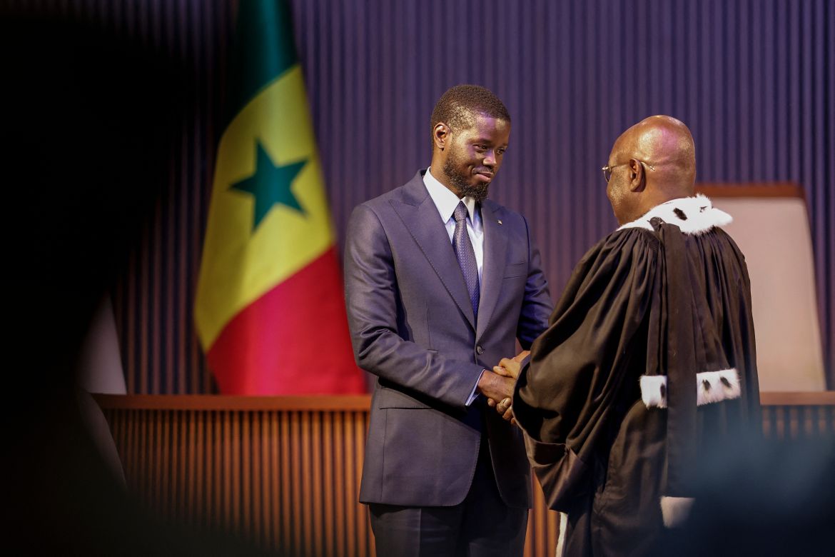 Bassirou Diomaye Faye (L) is sworn in as Senegal's President at an exhibition centre in the new town of Diamniadio near the capital Dakar